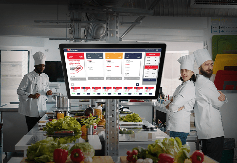 An AI-powered Kitchen Display System (KDS), a leading restaurant management software displayed in a restaurant kitchen showing orders on the Orderapp from TechRyde with chefs and other kitchen accessories present on the website.