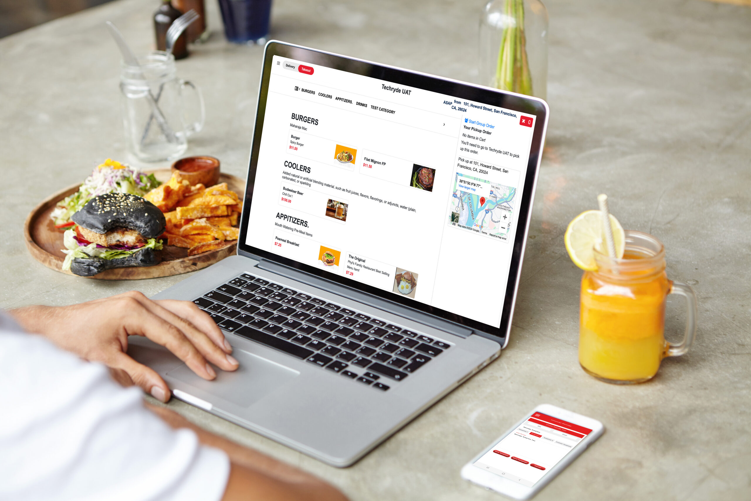 Customized online ordering site that integrates with the POS System and other restaurant management software shown on a laptop and mobile screen with other items around. From TechRyde is present on the website.<br />
