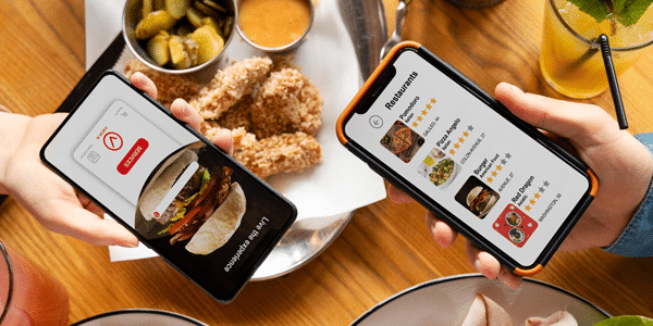 Restaurant staff member entering an order on a POS terminal.